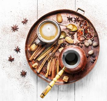 cezve and cup of coffee in copper tray with oriental spices