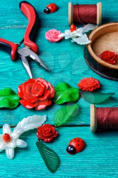Handmade decoration in the form of leaves and flowers and tools