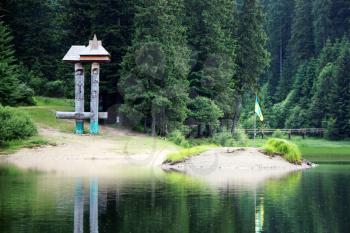 The sculpture and island on Lake Synevir in the Carpathian Mountain