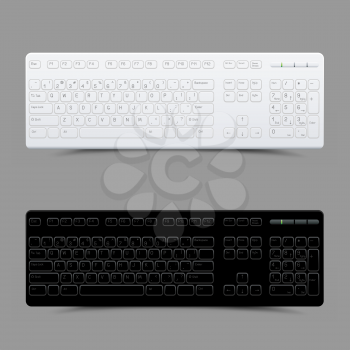 White and black computer keyboard with shadow on gray background