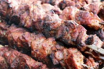 Cooked rosy delicious shish kebab barbecue meat. Hot grill food