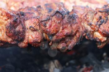 Cooked rosy delicious shish kebab barbecue meat on charcoal. Hot grill food