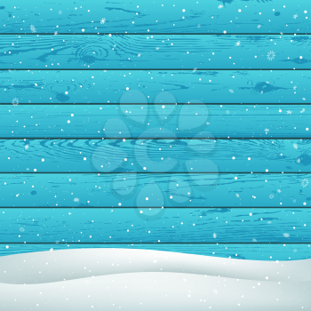 Winter snowfall on blue wood background. Christmas snowy hill. Holiday snowdrift azure wooden backdrop. Big and small snowflakes falling