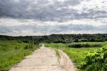 Stretch of road down the hill summer cloudy day