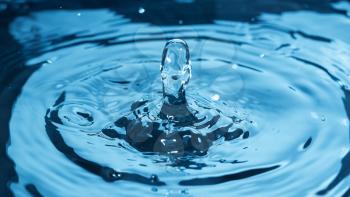 Water splash on surface as human face, studio shot