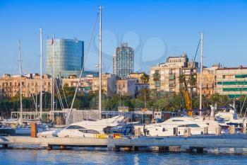 Sailing yachts and pleasure boats are moored in Barcelona Port