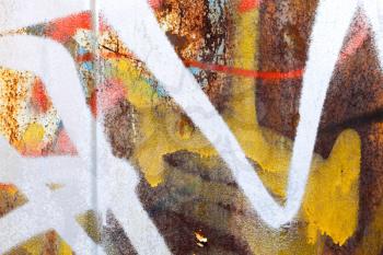Abstract colorful graffiti fragment on rusted metal wall