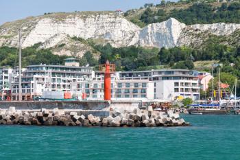 Balchik resort town. Entrance to port, red lighthouse on the pier. Coast of the Black Sea, Varna region, Bulgaria