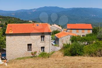 Corsican village landscape, living houses with red tile roofs. Petreto-Bicchisano, Corsica, France