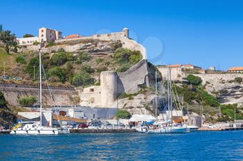 Cityscape of Bonifacio. Moored yachts, colorful houses and old stone fortress. Corsica island, France