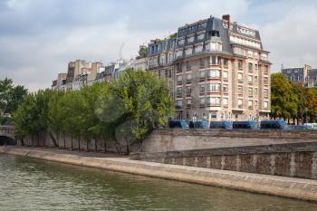 Trees and buildings are on Embankment of Seine river in Paris, France