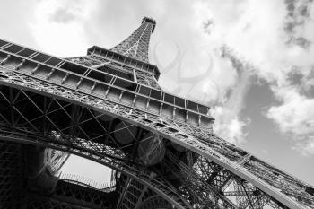 Looking up on Eiffel Tower, the most popular landmark of Paris, France. Monochrome photo