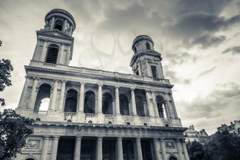 Facade of Saint-Sulpice, a Roman Catholic church in Paris, France. Black and white vintage stylized photo