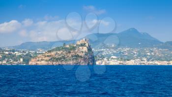Coastal landscape of Ischia with Aragonese Castle on the rocky island. Mediterranean sea coast, Italy