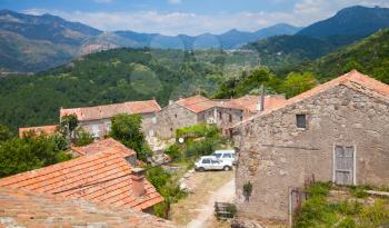 Rural landscape of South Corsica, old living houses and mountains on a background. Zerubia village, France