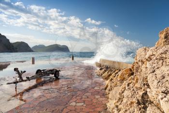 Stone breakwater with big waves. Petrovac, Montenegro, Adriatic Sea