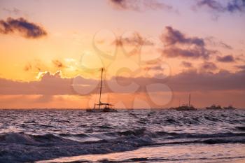 Colorful sunrise and yachts. Coastal landscape of Atlantic ocean. Dominican republic, Punta Cana