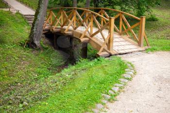 Small wooden bridge and walking lane in park, Trigorskoye village, Russia