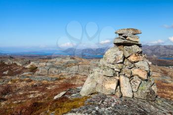 Granite stone cairn as a navigation mark on the top of Norwegian mountain