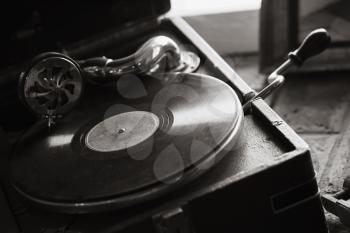 Vintage black portable wind-up gramophone, closeup black and white photo