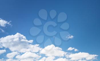 White cumulus clouds in blue sky, natural photo background texture