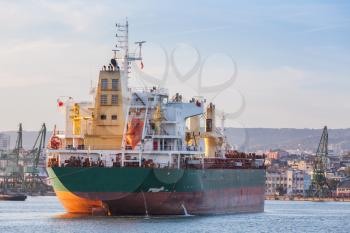 Bulk carrier stern, industrial ship with deck cranes loading in port of Varna, Bulgaria