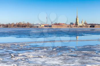 Winter landscape with floating ice on Neva river. Peter and Paul fortress in Saint-Petersburg, Russia