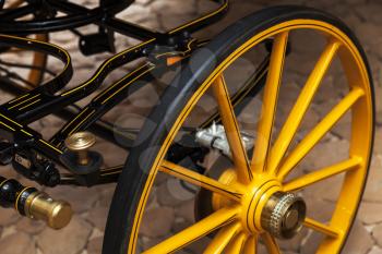 Yellow wheel of horse carriage with modern disc brake