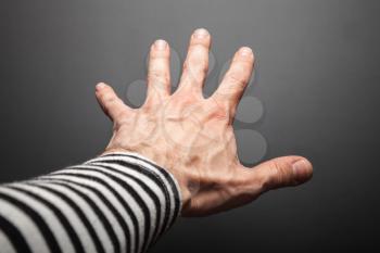 Strong sailor hand, close up photo with selective focus over dark gray background