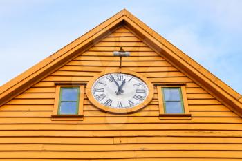 Traditional Norwegian wooden house with clock, Bergen Bryggen, Norway