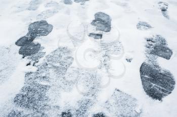 Footprints in ice-crushed ground on a winter urban street