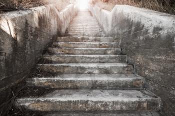 Abstract architecture background. Old concrete stairway with glowing end