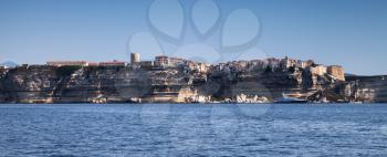 Old town on rocky coast. Seaside panorama of Bonifacio, mountainous Mediterranean island Corsica, Corse-du-Sud, France
