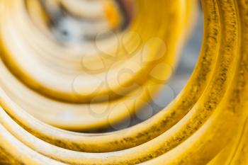 Yellow spiral bicycle parking lot stand, closeup photo with selective focus