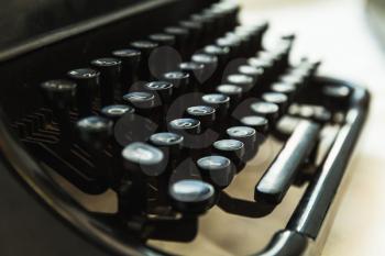 Vintage manual typewriter machine, closeup fragment with keys, photo with soft selective focus