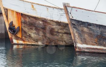 Fragments of old wooden fishing boats moored in port of Reykjavik, Iceland
