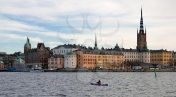 View of old Stockholm town with river and oarsman