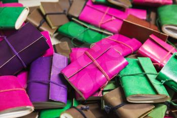 Pile of colorful notepads in leather bindings