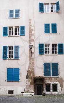 Old living house facade with blue wooden shutters. Geneva, Switzerland