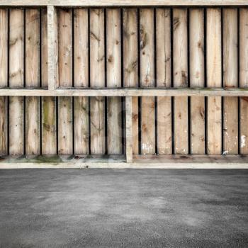 Abstract interior fragment, rough wooden shelves on concrete floor