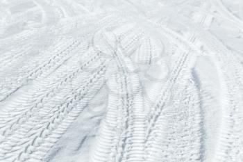 Car tire tracks on winter road. Background photo texture