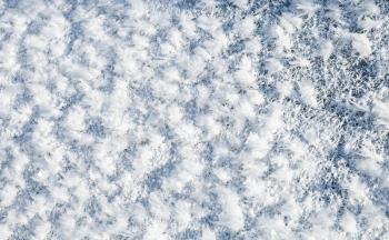 Close up photo of surface hoar, the most common form of hoarfrost consists of fluffy ice crystals. Winter natural background texture