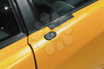 Luxury yellow roadster fragment, door lock. Italian car design