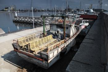 Old grungy pleasure boat lays on the quay in Burgas port, Bulgaria