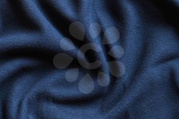Texture of fleece, dark blue soft napped insulating fabric made from polyester, wavy pattern