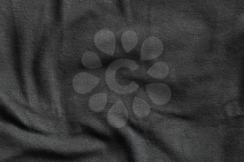 Texture of fleece, soft napped insulating fabric made from polyester, dark gray wavy pattern