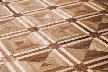 Classical old wooden parquet design, geometric pattern with triangles and squares. Background photo texture