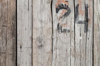 Rough wooden wall with black painted number 24, background photo texture