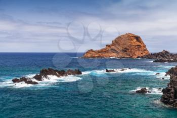 Coastal landscape with rocks in ocean water. Porto Moniz, Madeira island, Portugal