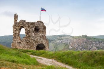Russian flag mounted on ruins of ancient fortress Calamita in Inkerman, Crimea